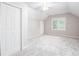 Spacious bedroom featuring plush carpet, a window, and a ceiling fan offers a comfortable retreat at 4806 Deer Chase, Powder Springs, GA 30127