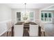 Formal dining room with stylish chandelier, modern table and chairs, and large windows at 4806 Deer Chase, Powder Springs, GA 30127