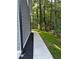 View of the side of the house with landscaped mulch bed and green grass at 4806 Deer Chase, Powder Springs, GA 30127