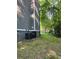 Exterior view of the house features an AC unit and a grassy area beside a wooded area at 4806 Deer Chase, Powder Springs, GA 30127