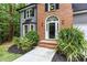 Inviting entryway with brick accents and lush landscaping, leading to a charming front door and bay window at 4806 Deer Chase, Powder Springs, GA 30127