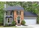 Charming two-story home features a brick archway and a welcoming front door with lovely landscaping at 4806 Deer Chase, Powder Springs, GA 30127