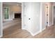 Hallway with a view to a living room with fireplace and wood floors at 4806 Deer Chase, Powder Springs, GA 30127