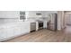 Bright kitchen featuring white cabinets, stainless steel appliances, and sleek countertops at 4806 Deer Chase, Powder Springs, GA 30127