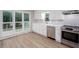 Bright kitchen with white cabinets, quartz countertops, stainless steel appliances, and a backyard view at 4806 Deer Chase, Powder Springs, GA 30127