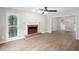 Cozy living room features a fireplace, new floors, and an open view of the dining room at 4806 Deer Chase, Powder Springs, GA 30127