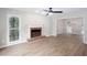 Spacious living room with a brick fireplace and ample natural light from nearby windows at 4806 Deer Chase, Powder Springs, GA 30127