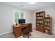 Bright office space with bookshelves, neutral carpet, and a computer desk with a chair at 4806 Deer Chase, Powder Springs, GA 30127
