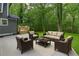 Outdoor patio space features furniture and a peaceful view, surrounded by lush greenery and natural light at 4806 Deer Chase, Powder Springs, GA 30127