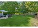 Expansive backyard with a patio area, hot tub, shed, and lush greenery at 512 Plantation Blvd, Lawrenceville, GA 30046