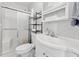 Bright bathroom featuring a white marble backsplash, white vanity, and shower with sliding doors at 512 Plantation Blvd, Lawrenceville, GA 30046
