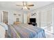 Comfortable bedroom featuring neutral paint, ceiling fan, and attached bathroom at 512 Plantation Blvd, Lawrenceville, GA 30046