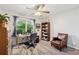 Bright bedroom with a large window, hardwood floors, and ceiling fan at 512 Plantation Blvd, Lawrenceville, GA 30046