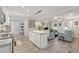 Open-concept living space featuring a kitchen island, adjacent living room and hardwood floors at 512 Plantation Blvd, Lawrenceville, GA 30046