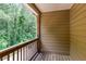 View of exterior balcony with wooden flooring and railings overlooking natural greenery at 529 Ridge View Crossing Xing, Woodstock, GA 30188
