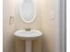 Cozy powder room with pedestal sink, oval mirror, and neutral wall color at 529 Ridge View Crossing Xing, Woodstock, GA 30188