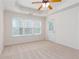 Comfortable bedroom featuring a tray ceiling with ceiling fan, carpet flooring and access to the exterior at 529 Ridge View Crossing Xing, Woodstock, GA 30188