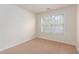 Well-lit room featuring neutral walls, carpet flooring and a window with blinds at 529 Ridge View Crossing Xing, Woodstock, GA 30188