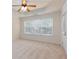 Spacious bedroom with a fan and tray ceiling, window, and neutral carpeting at 529 Ridge View Crossing Xing, Woodstock, GA 30188