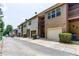 View of townhouses, each with a private garage, balcony, and neutral-toned siding at 529 Ridge View Crossing Xing, Woodstock, GA 30188