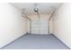 Inside of a two car garage with gray epoxy flooring and a white door at 529 Ridge View Crossing Xing, Woodstock, GA 30188