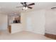 Inviting living space flowing into kitchen with breakfast bar, complete with modern ceiling fan at 529 Ridge View Crossing Xing, Woodstock, GA 30188