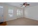 Open living area with carpet and large windows, offering lots of natural light and a modern ceiling fan at 529 Ridge View Crossing Xing, Woodstock, GA 30188