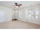 Bright living room with neutral carpet, ceiling fan, and large windows letting in natural light at 529 Ridge View Crossing Xing, Woodstock, GA 30188