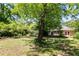 Spacious backyard featuring a lush lawn, mature trees, and a cozy deck at 1405 May Se Ave, Atlanta, GA 30316