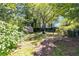 View of a well-kept backyard with a storage shed, pergola, and brick-lined pathway amidst lush greenery at 1405 May Se Ave, Atlanta, GA 30316