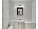 Bathroom featuring a pedestal sink, toilet, and tiled bathtub with a shower at 1405 May Se Ave, Atlanta, GA 30316