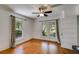 Bright bedroom featuring hardwood floors, a ceiling fan, two windows, and curtains at 1405 May Se Ave, Atlanta, GA 30316