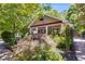 Charming home exterior featuring a covered front porch, lush landscaping, and mature trees at 1405 May Se Ave, Atlanta, GA 30316