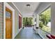 View of the front porch featuring a wooden front door with art deco window panes and chairs at 1405 May Se Ave, Atlanta, GA 30316