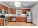 Modern kitchen with stainless steel appliances, wood cabinets, and granite countertops at 1405 May Se Ave, Atlanta, GA 30316