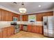 Kitchen featuring stainless steel appliances, granite countertops, tile backsplash, and hardwood floors at 1405 May Se Ave, Atlanta, GA 30316