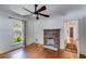 Bright living room featuring a brick fireplace, hardwood floors, and large window at 1405 May Se Ave, Atlanta, GA 30316