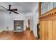 Bright living room featuring a brick fireplace, hardwood floors, and an open doorway at 1405 May Se Ave, Atlanta, GA 30316