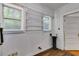 Utility room with white shiplap walls, laminate flooring, wire racks, and two windows with blinds at 1405 May Se Ave, Atlanta, GA 30316