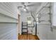 Utility room with white shiplap walls and ceiling, wood laminate flooring, and wire rack shelving at 1405 May Se Ave, Atlanta, GA 30316