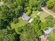 Aerial view of the property reveals mature trees, a long driveway, and outbuildings at 265 Tamea Trl, Covington, GA 30014