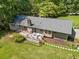 Aerial view of home showcasing the back patio and spacious yard with mature trees at 265 Tamea Trl, Covington, GA 30014