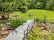 Landscaped backyard featuring a serene pond with a small wooden bridge at 265 Tamea Trl, Covington, GA 30014