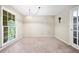 This bedroom offers plush carpeting, a large window, and a neutral color palette at 265 Tamea Trl, Covington, GA 30014