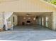 Spacious garage converted into a partially enclosed lounge area with brick columns at 265 Tamea Trl, Covington, GA 30014