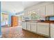 Bright kitchen featuring white cabinets, hardwood countertops, and a view to the laundry room at 265 Tamea Trl, Covington, GA 30014