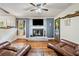 Cozy living room with a brick fireplace, wood floors, and decor, creating a warm and inviting atmosphere at 265 Tamea Trl, Covington, GA 30014