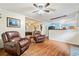 Inviting living area with hardwood floors, comfortable seating, and an open layout to the kitchen at 265 Tamea Trl, Covington, GA 30014
