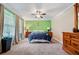 Comfortable primary bedroom with large dresser and bright green accent wall at 265 Tamea Trl, Covington, GA 30014