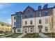 Stylish townhome shows a brick facade, multi-pane windows, and a neatly landscaped front yard on a sunny day at 445 Breccia Run, Mcdonough, GA 30253